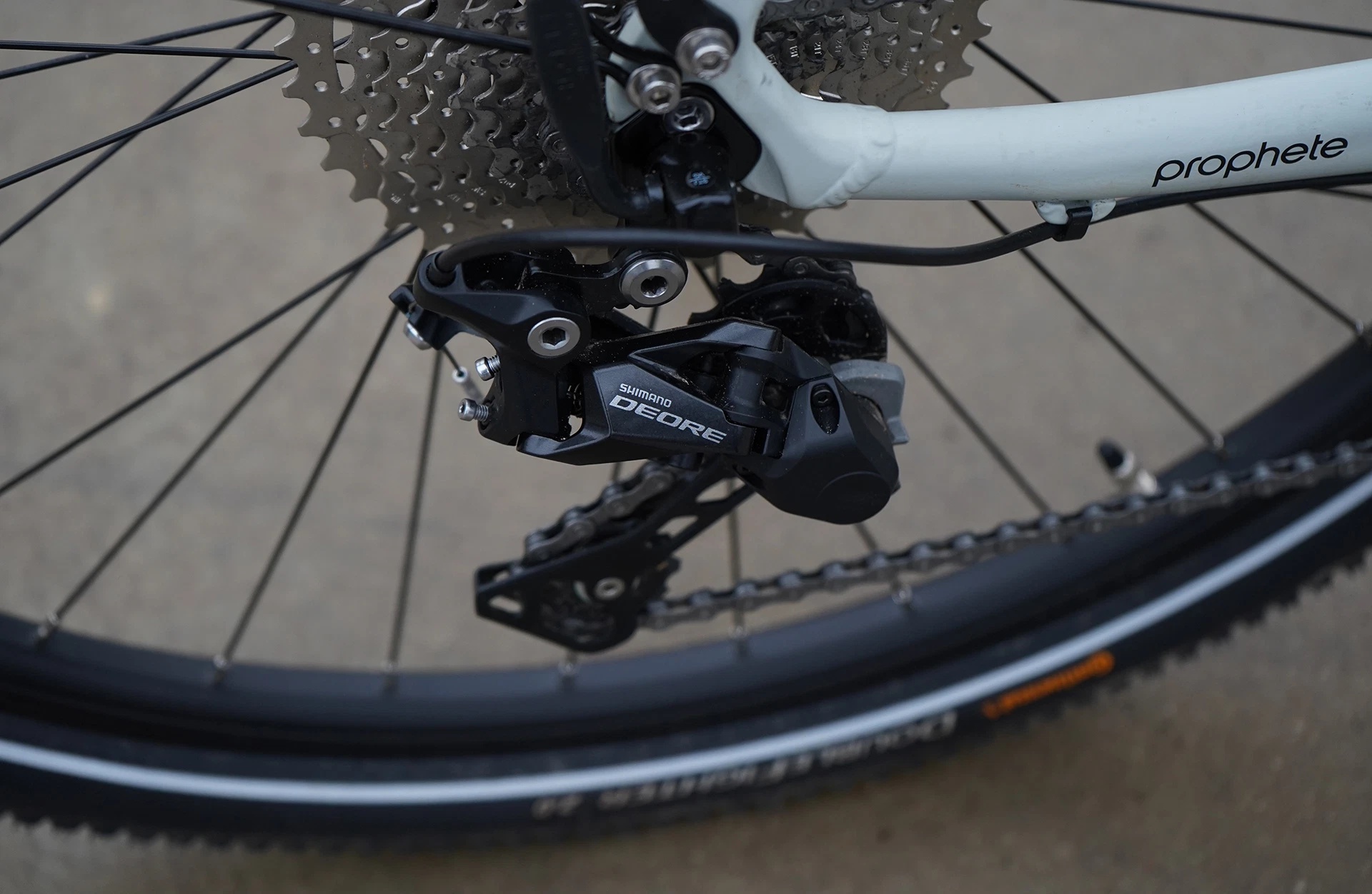 Bildausschnitt Detailbild Shimano Deore Schaltwerk mit Kassette und Kette am Hinterrad auf unscharfem Untergrund