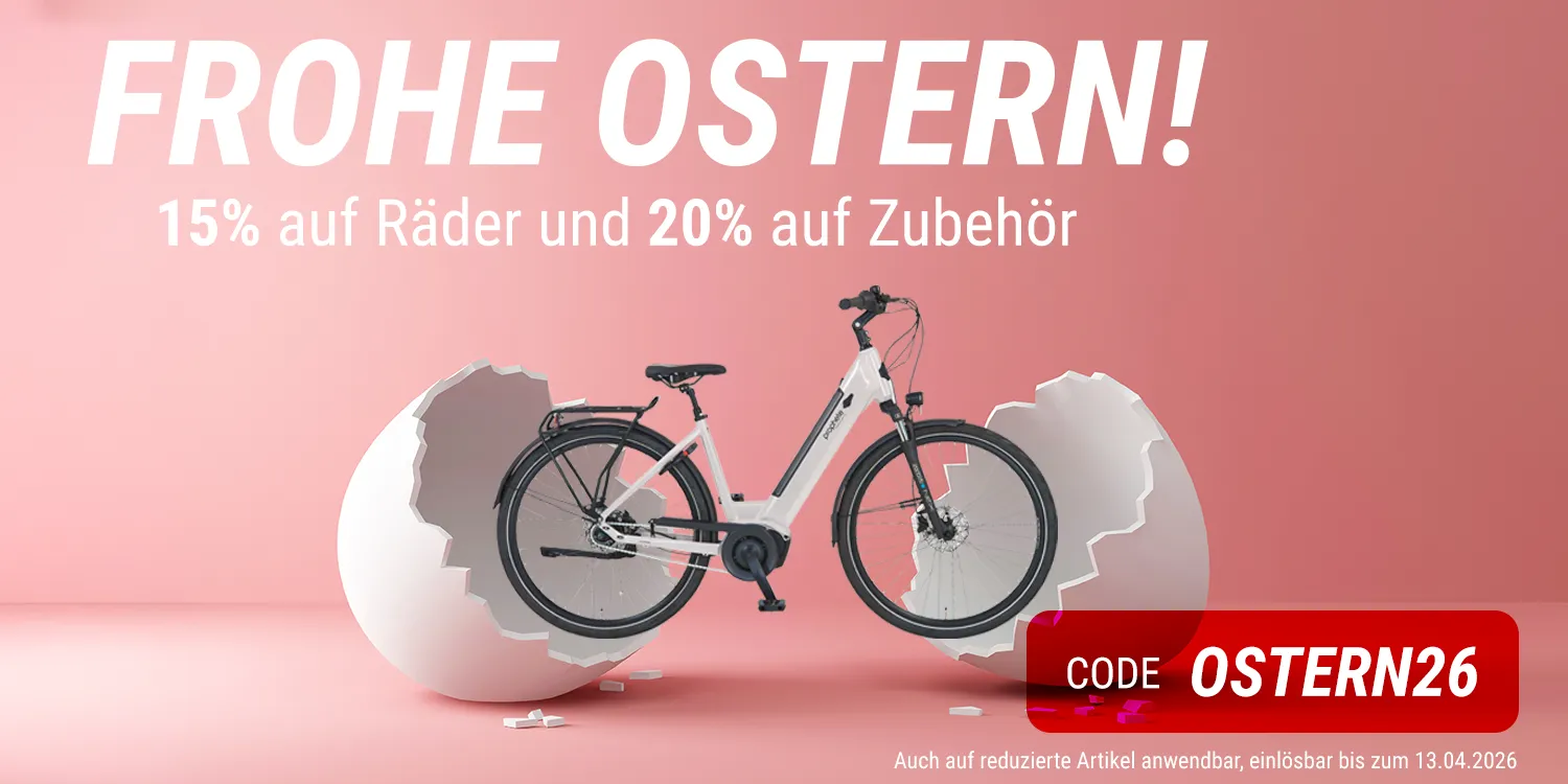 Werbegrafik zu Ostern mit einem weißen E‑Bike, das aus einer aufgebrochenen Eierschale vor rosa Hintergrund steht. Text: Frohe Ostern! 15 % auf Räder und 20 % auf Zubehör sowie Rabattcode OSTERN26.