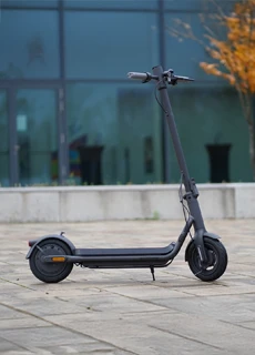 E-Scooter One in Schwarz vor Glasfassade